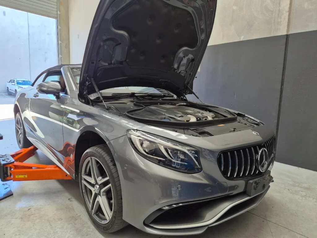 Mercedes-Benz vehicle in a garage with the hood raised