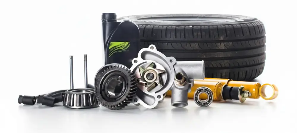 Car parts including a tyre, engine components, and oil container